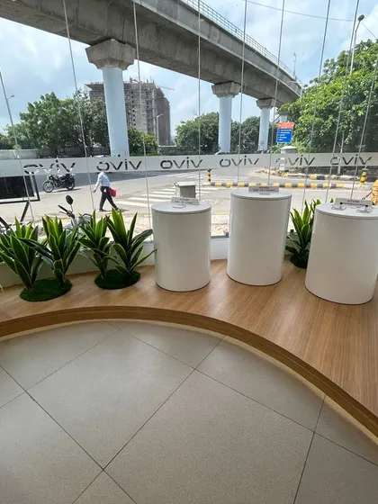 A curved seating area by the large glass window of the Ahmedabad showroom. This design feature takes advantage of the view and natural light, creating a nice spot for customers to wait or try out devices.