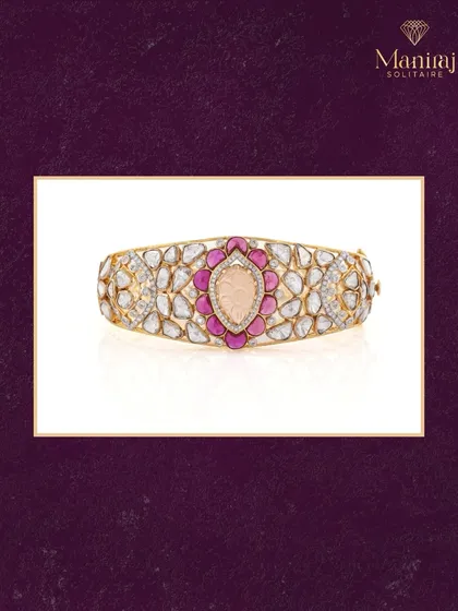 This Polki kada is a blend of bold beauty and timeless charm. It features uncut diamonds, ruby pink accents, and a carved center stone, making it a standout piece for any occasion.
