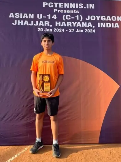A solo shot of Aarav Dhekial with his doubles trophy from the Asian U14 Championship. This victory is a great confidence booster for his future competitions.