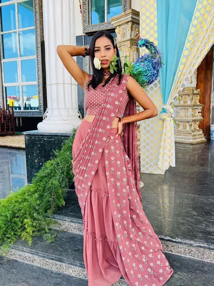 A full-length view of this unique and modern bridesmaid outfit. The makeup is kept fresh and glowing to complement the stylish ensemble.