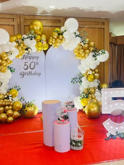 For this 50th milestone celebration, I designed a classic and elegant backdrop. The combination of gold and white balloons, paired with large marquee numbers, provides a perfect focal point for cake cutting and photos.