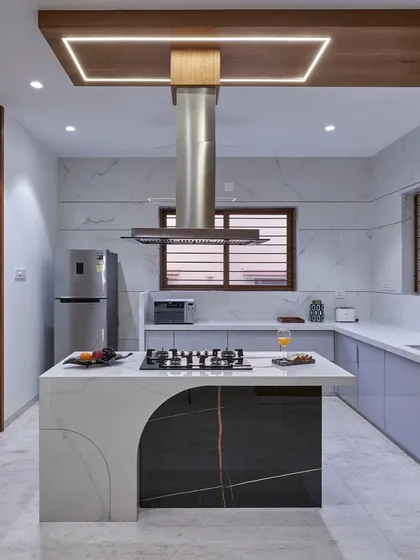 This kitchen is the heart of the home, designed for both serious cooking and casual gatherings. The statement island with an integrated cooktop, marble finishes, and custom cabinetry combines high functionality with a sleek, modern aesthetic.
