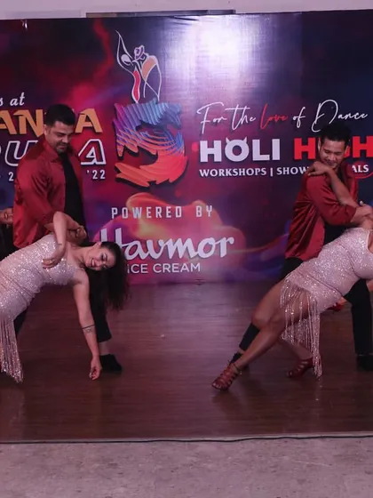 A dynamic action shot of our performance team executing a synchronized dip during the Danza Pura festival. Our choreographies are designed to be both challenging and visually stunning.