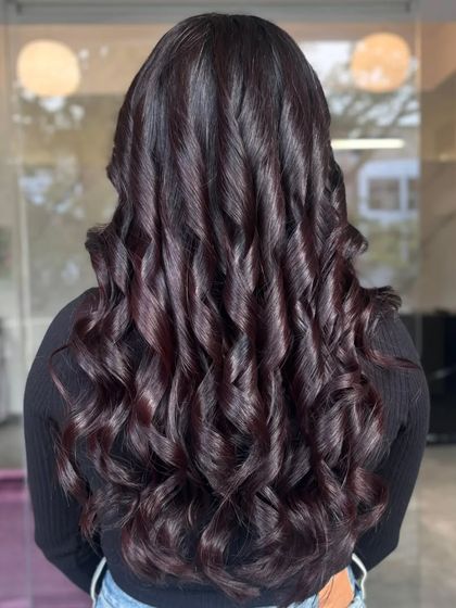This look features tight, defined curls that make the rich color even more dramatic.