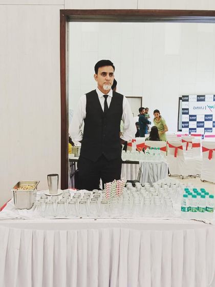 A full view of our bartender at his station, ready for a full-day corporate catering event.