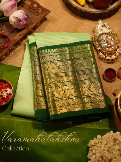 We believe every festival deserves a touch of grandeur. This stunning Kanjivaram in shades of green, styled with traditional puja elements, embodies the spirit of celebration and our rich cultural heritage.
