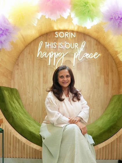 A happy guest posing at our signature photo spot. Seeing clients leave with a smile is the best part of my day.