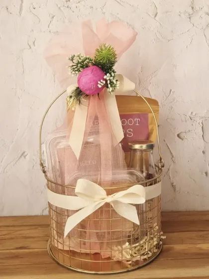 A simple yet elegant wireframe basket hamper, tied with a cream ribbon and filled with our delicious baked goods.