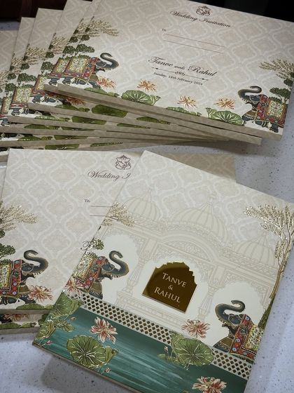 A bestseller hardback invitation featuring a classic design with royal elephants and lotus motifs. This timeless card is perfect for any traditional Indian wedding.