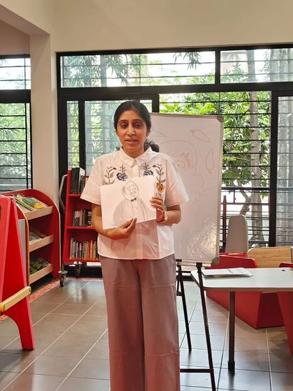 Author Pika Nani holding up a drawing during her interactive session. She had the kids completely engaged with brain-scrambling activities and puzzles.