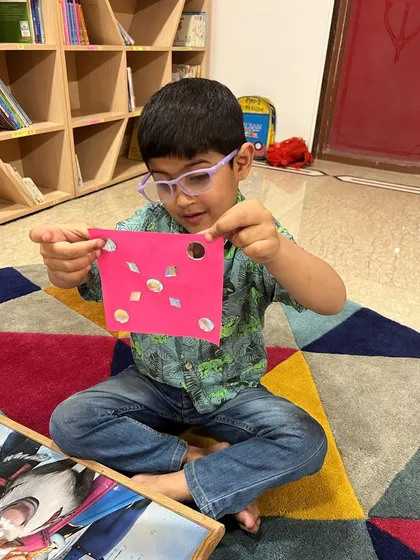 A student shows off the shape-based craft he made during our spring camp. These activities help develop fine motor skills and shape recognition.