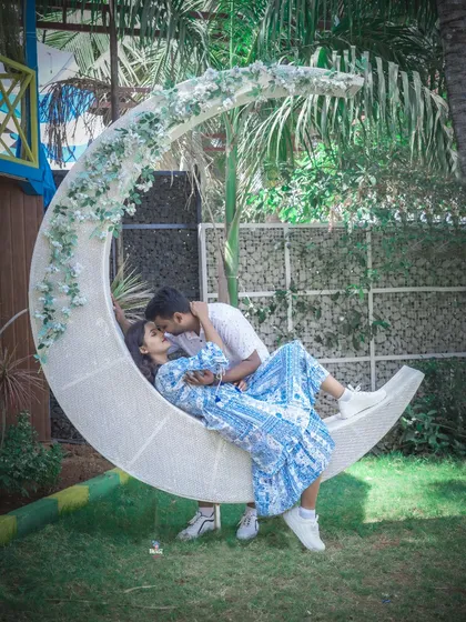 An intimate kiss on a crescent moon swing. This whimsical studio prop adds a touch of magic to any couple's photoshoot.