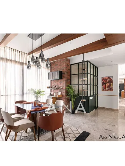 The dining area in Apartment 704 showcases our use of material and color to create vibrant living spaces. Exposed brick, a dark green powder room enclosure with fluted glass, and industrial-style lighting come together in a contemporary design.