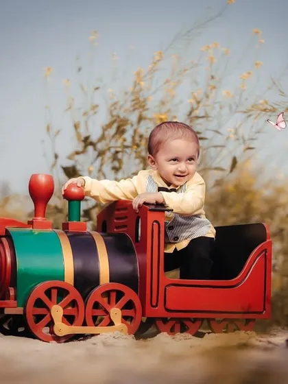 Chasing butterflies from his toy train. This shot is full of movement and wonder, capturing the magic of childhood imagination.