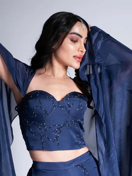 For a cocktail party or reception, a touch of drama can be stunning. Here, I created a captivating smokey eye and a sculpted look to complement this deep navy blue ensemble, perfect for an unforgettable evening.
