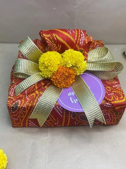A slightly different angle of our bandhani-wrapped Holi gift, showing the beautiful texture and colors.