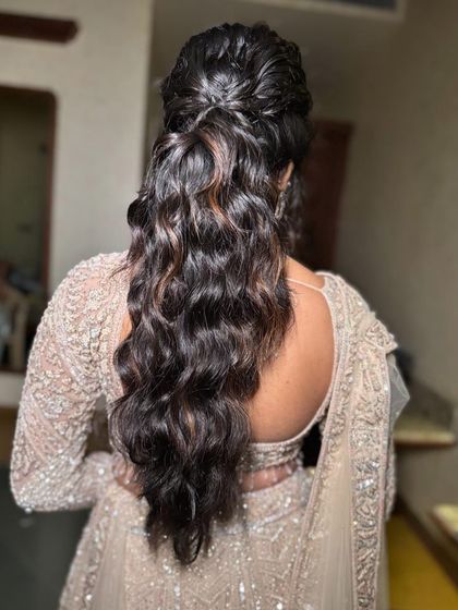 A messy ponytail with lots of volume and texture. This is a great choice for a bride who wants a modern and stylish look.