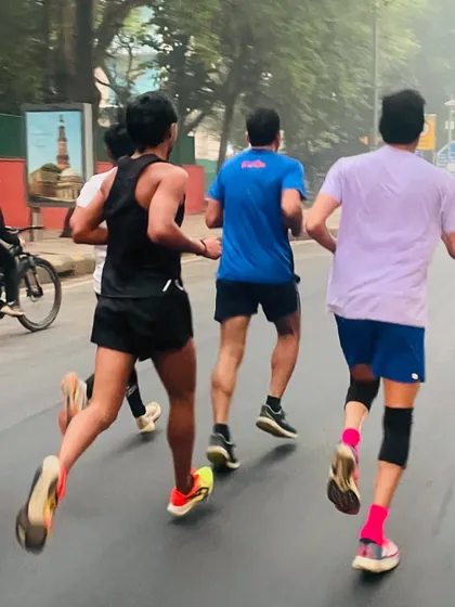 A view from behind as the group runs towards India Gate. This shot shows the power and rhythm of the pack as we move through the streets of Delhi.