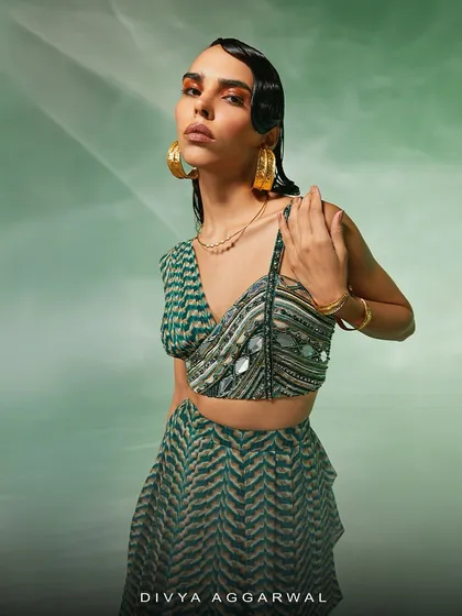 An artistic shot of the Verity set, showcasing the modern mirror work on the asymmetrical blouse and the flow of the printed skirt.