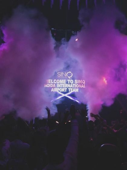 Purple smoke fills the air during a corporate event at SinQ, Goa.