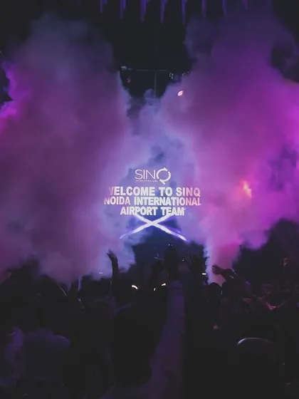 Purple smoke fills the air during a corporate event at SinQ, Goa.