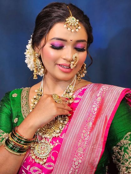 A close-up of the eye makeup for this Maharashtrian bridal look. The vibrant pink and gold eyeshadow is blended perfectly to create a captivating effect.