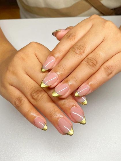 A modern French manicure with a metallic lime-green tip on almond-shaped nails.