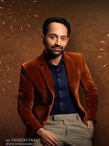 A promotional shot for Kavitha Gold & Diamonds featuring Fahadh Faasil. For male grooming in commercial shoots, the goal is a natural, polished finish that looks clean and professional on camera.