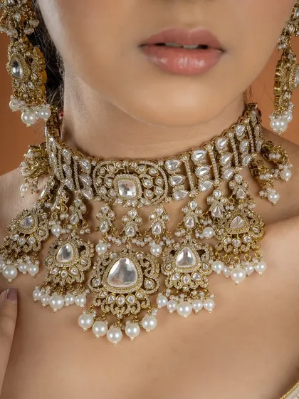 A close-up of the intricate royal choker set. The detail in the Kundan work and the delicate pearl drops are a testament to the skill of our karigars.