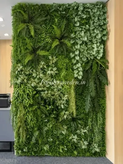 An artificial vertical garden installed in an office space, adding a refreshing natural element next to a workspace and doorway.
