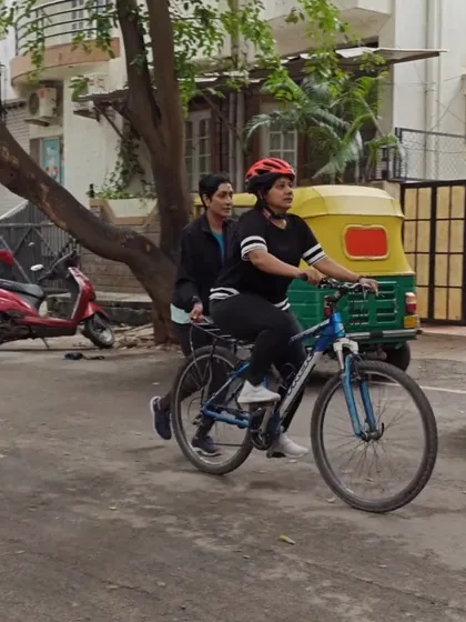 Learning to ride as an adult can feel intimidating, but my patient, hands on instruction makes it easy. Here, an instructor provides gentle support from behind, helping a learner get used to the motion of pedaling on our quiet Indiranagar streets.