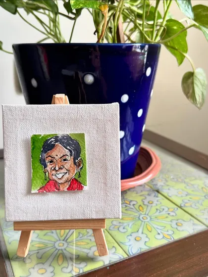 A mini portrait of my art buddy, Swati, displayed on a tiny easel. She is a brilliant and resilient artist who inspires me to grow.