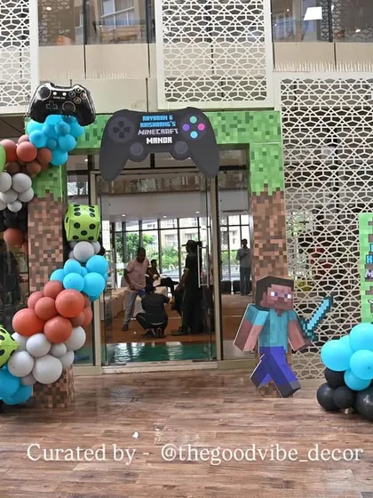 The entrance to the Minecraft party, featuring a balloon arch with game characters and dice, setting the tone for an adventurous celebration from the moment guests arrived.