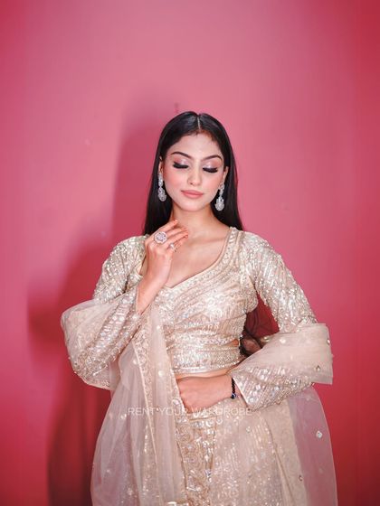 An elegant close-up that focuses on the soft glam makeup and the texture of the outfit.