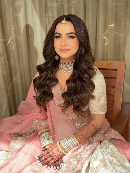 Another shot of the beautiful soft glam look. The voluminous waves and radiant makeup create a romantic and timeless bridal style.