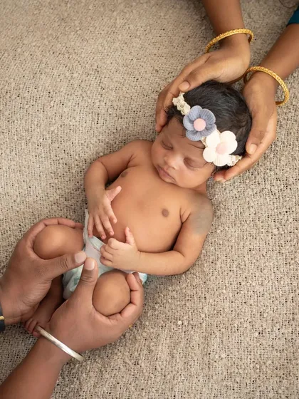 The tiniest details hold the biggest love. A newborn's hand wrapped around their parent's finger is one of the most precious sights. I focus on these small, tender moments that you'll cherish as they grow.
