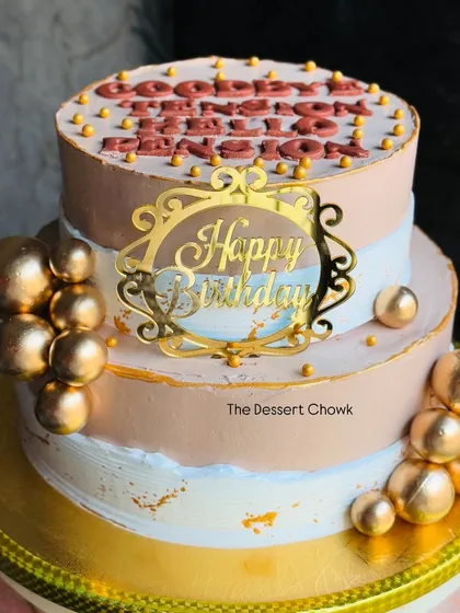 A fun and stylish two-tier cake for a retirement party. The message "Goodbye Tension, Hello Pension" adds a touch of humour to this elegant gold-accented chocolate mousse cake.