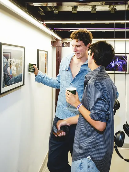 Guests discussing the artwork on display. Our events are designed to spark conversation and build community around a shared love for music and culture.
