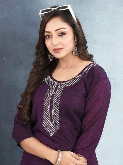 This purple vichitra silk kurta has a simple, elegant design with stone work on the neckline. It's a great choice for a comfortable yet put-together look.