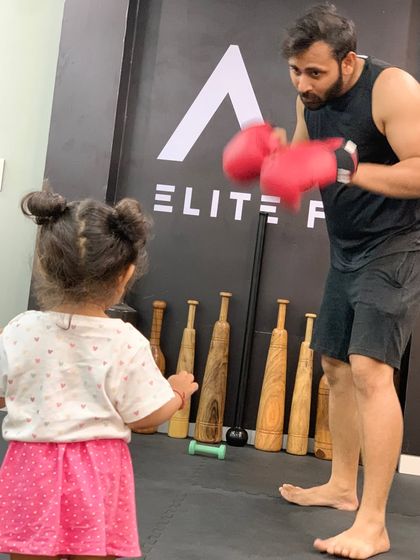 My daughter watching her dad practice boxing at our studio. Starting her exposure to fitness early.