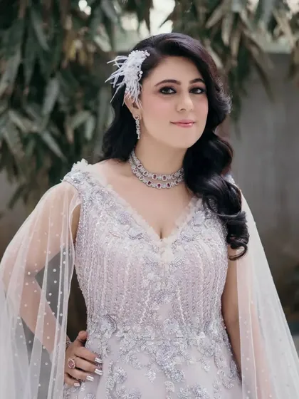 A final look at the client's stunning hairstyle and gown. The combination of the detailed dress and the classic Hollywood waves is perfect for making an entrance.