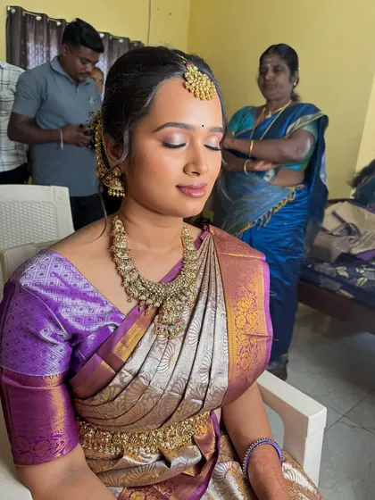 Swathy with her eyes closed, showcasing the soft, blended eyeshadow. The look is perfect for brides who prefer a more natural and understated style.