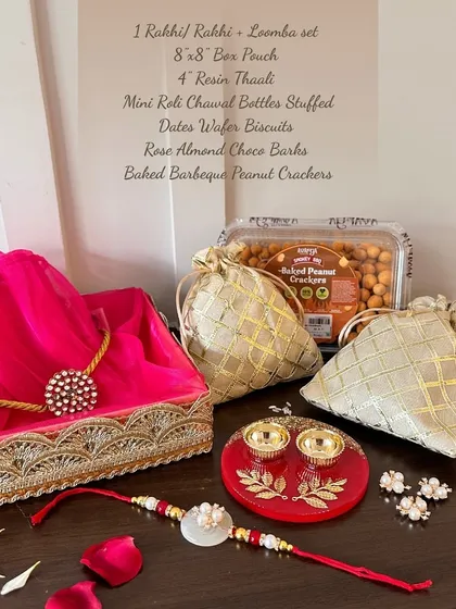 My Rakhi hampers are a complete celebration in a box. This one includes a Rakhi and Lomba set, a beautiful resin thaali, and a selection of gourmet treats, all thoughtfully arranged to honor the special bond of siblings.