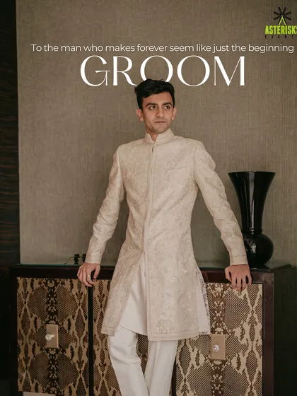 A stylish portrait of the groom in his elegant off-white sherwani, looking sharp and ready for his big day.