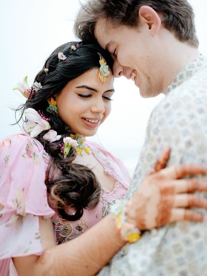 A close-up, intimate portrait of the couple on the beach. Their gentle embrace and happy smiles tell a story of pure love and contentment.