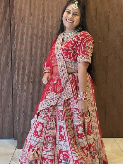 Another angle of our beautiful client in the red doli-baraat rental lehenga. The fit is perfect and she looks ready for her big day.