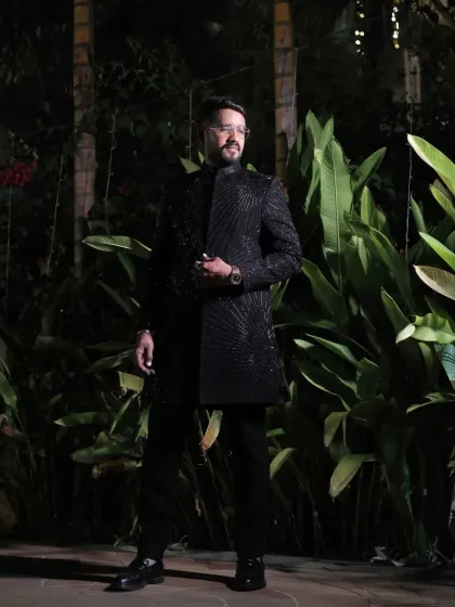 A client ready for his evening event in a fully embroidered black sherwani. The tone-on-tone detailing creates a look that is both luxurious and understated.