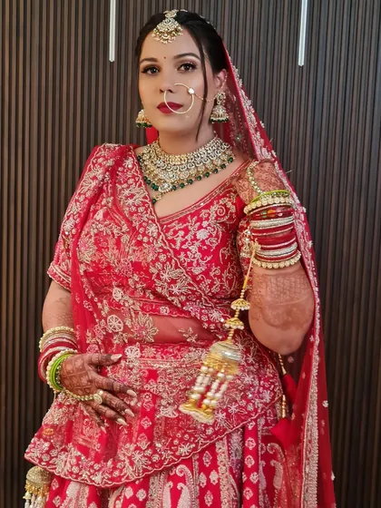 A full shot of my red bride, looking absolutely regal in her lehenga and heavy jewelry.