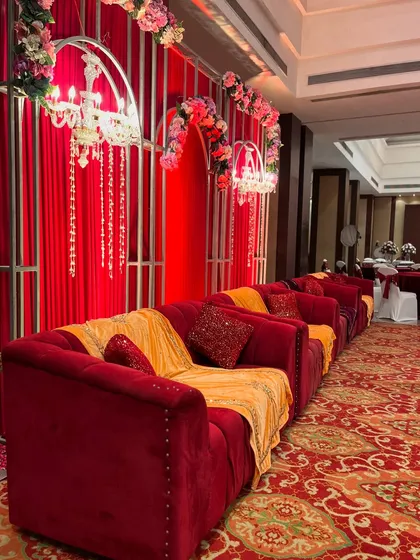 A cozy seating arrangement at Jaypee Green Resort, with the catering and bar area visible in the background.
