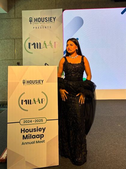 Posing next to the branding for the Housiey "Milaap" Annual Meet. I always make sure to highlight the client and the theme of the event.